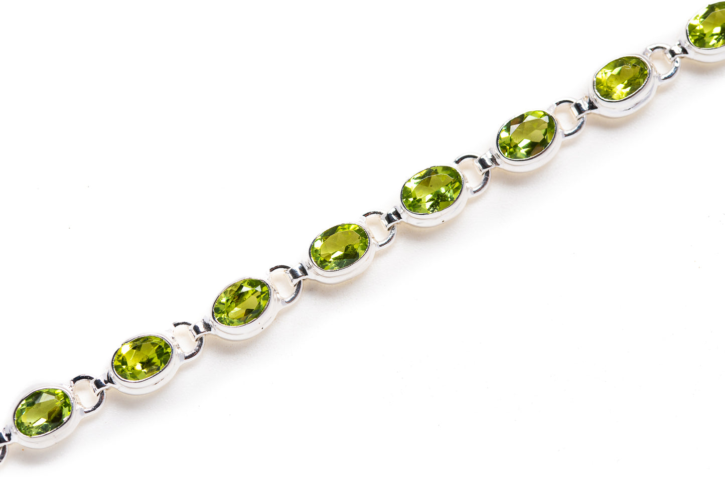 Peridot bracelet with oval green gemstones on silver link chain