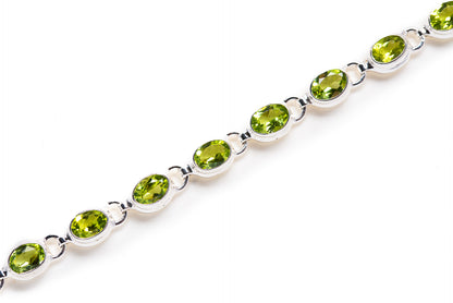 Peridot bracelet with oval green gemstones on silver link chain