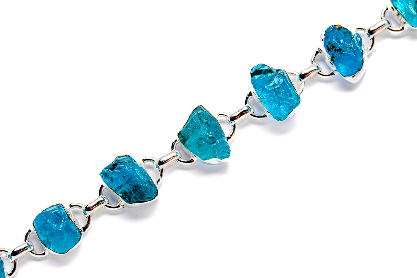 Rough apatite bracelet featuring turquoise rough stones on silver link chain
