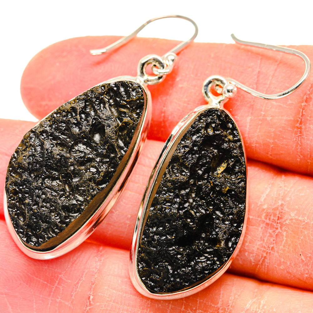 Close-up 925 sterling silver tektite teardrop earrings, black stone with gold flecks