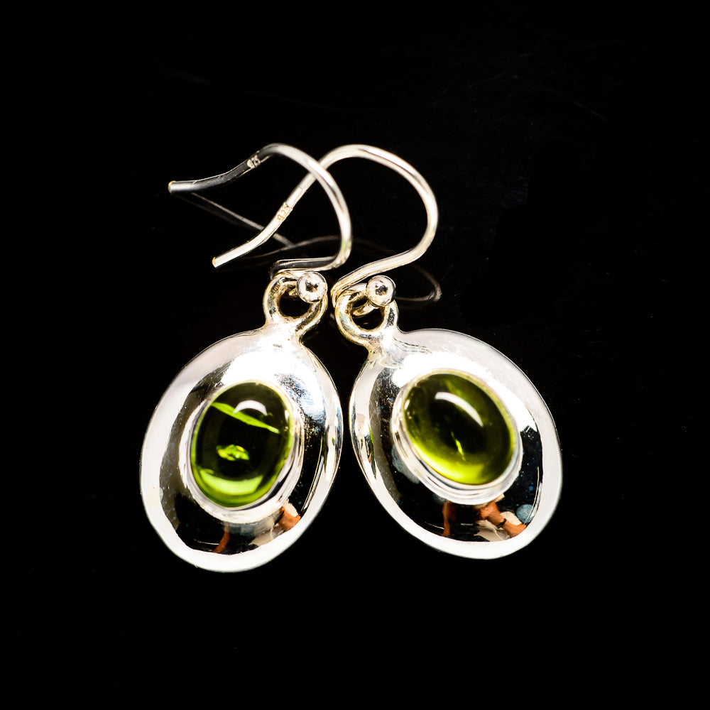 Sterling silver peridot earrings with green teardrop stones in bezel settings