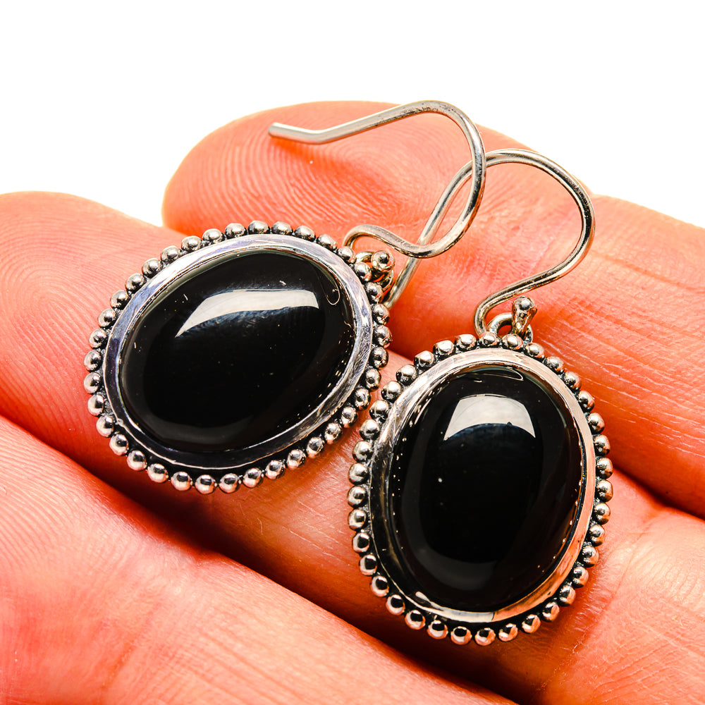 Black onyx drop earrings with oval stones and beaded silver border, hook style