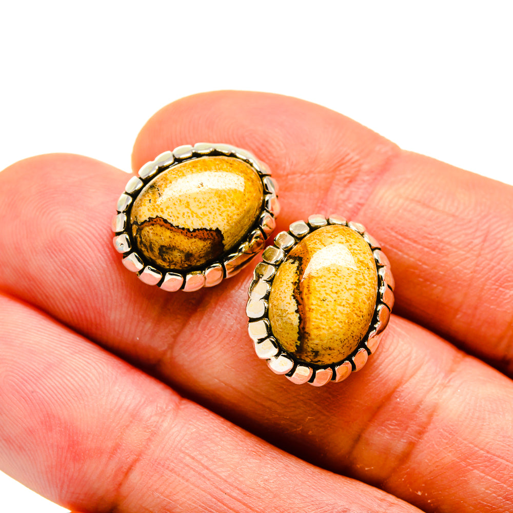 Oval picture jasper stud earrings on hand: yellow-brown stone with scalloped 925 sterling silver bezel