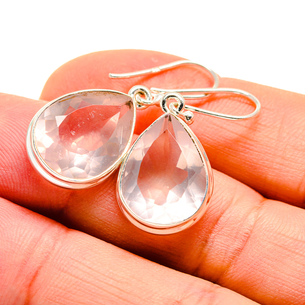 Sterling silver drop earrings with faceted pink teardrop gemstones on hooks