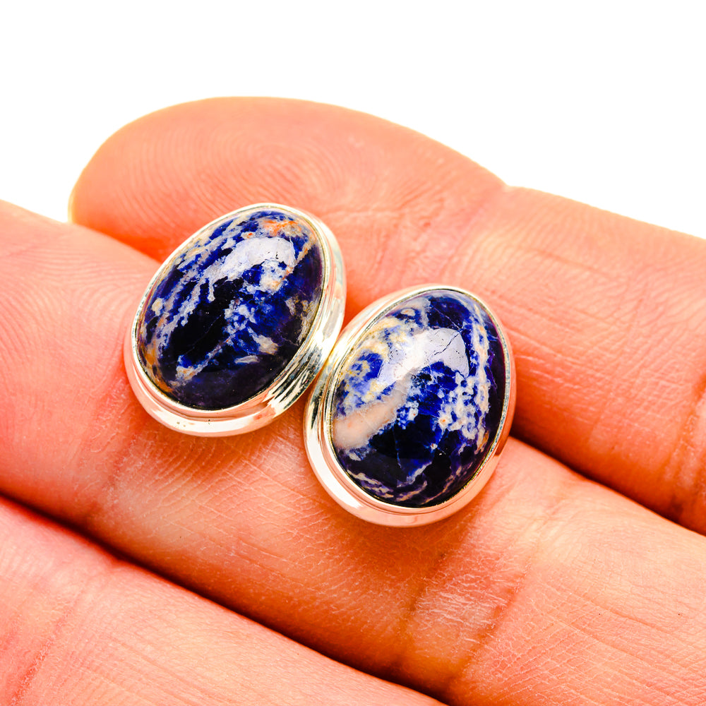 Oval sodalite stud earrings on hand, blue and white stone in sterling silver