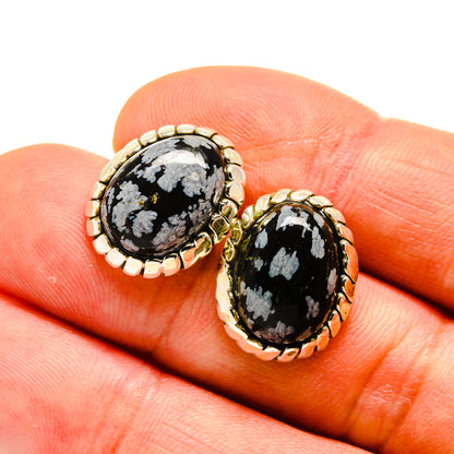 Snowflake obsidian stud earrings, oval black stones with white veining, gold-tone halo