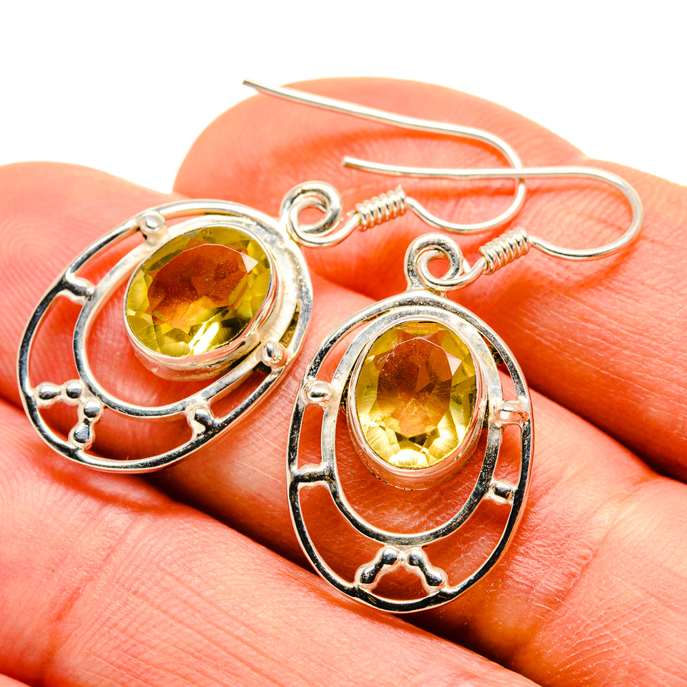 Sterling silver citrine drop earrings with oval faceted yellow gemstones and ornate frames