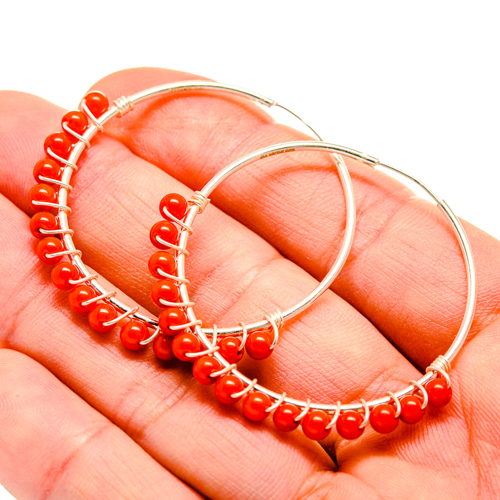 Red onyx-style beaded hoop earrings in 925 sterling silver, close-up on red beads