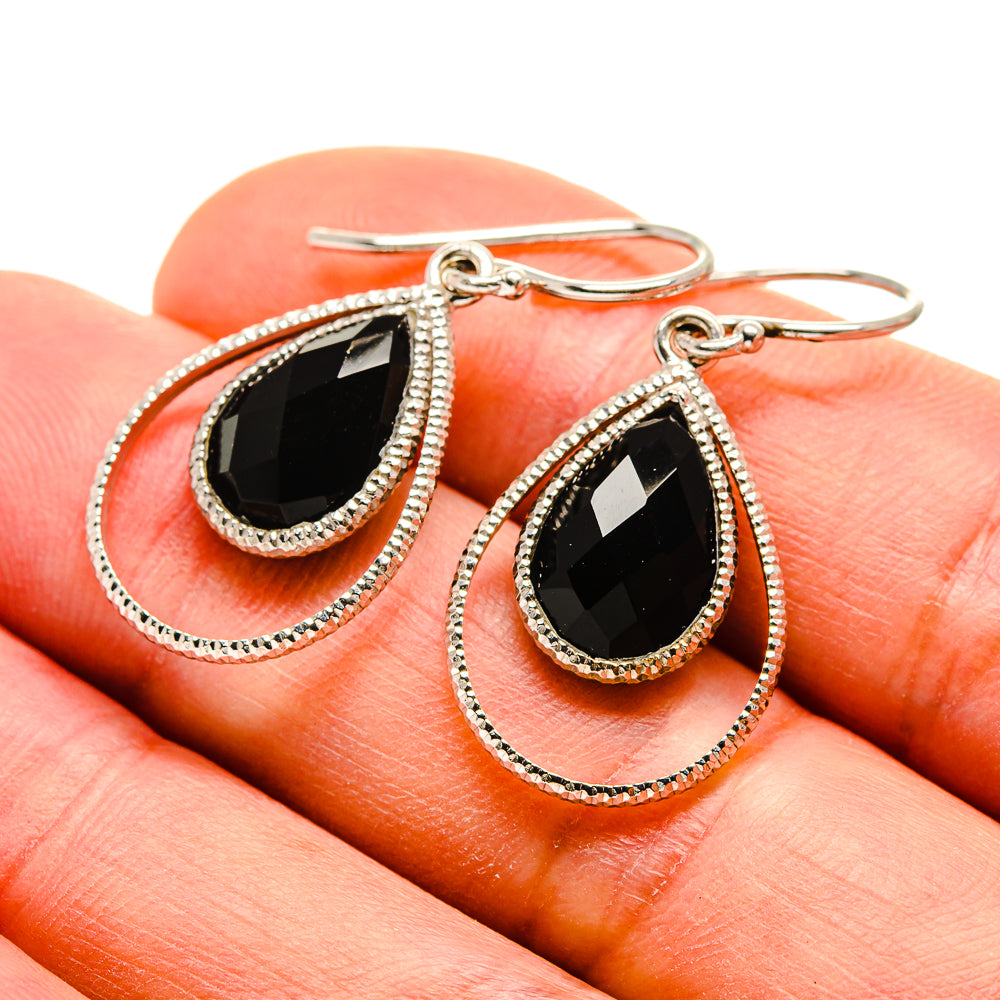 Black onyx teardrop earrings with silver bezel, rope-texture border, fishhook backs