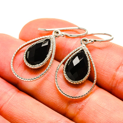 Black onyx teardrop earrings with silver bezel, rope-texture border, fishhook backs