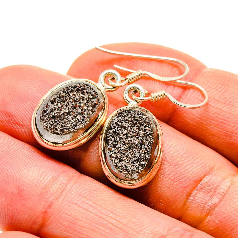 Gold-tone oval druzy earrings with fishhook backs, dark glitter centers