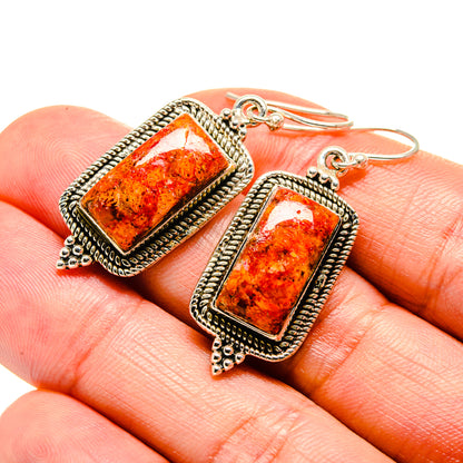 Rectangular sponge coral earrings with silver-tone rope border and lever-back hooks, closeup