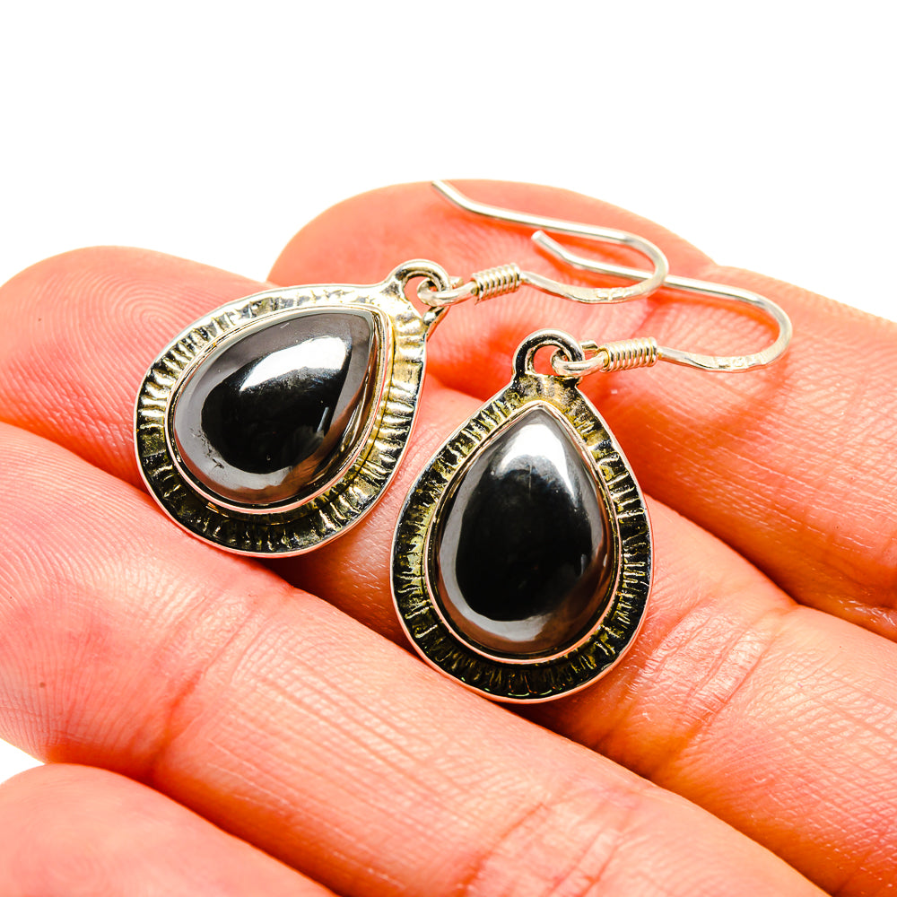 Hematite teardrop earrings close-up, gold-tone 925 hooks with black teardrop stones