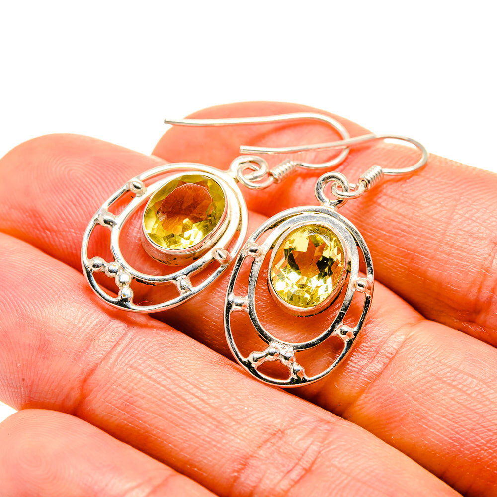Sterling silver citrine earrings with oval faceted yellow stones and decorative oval frames