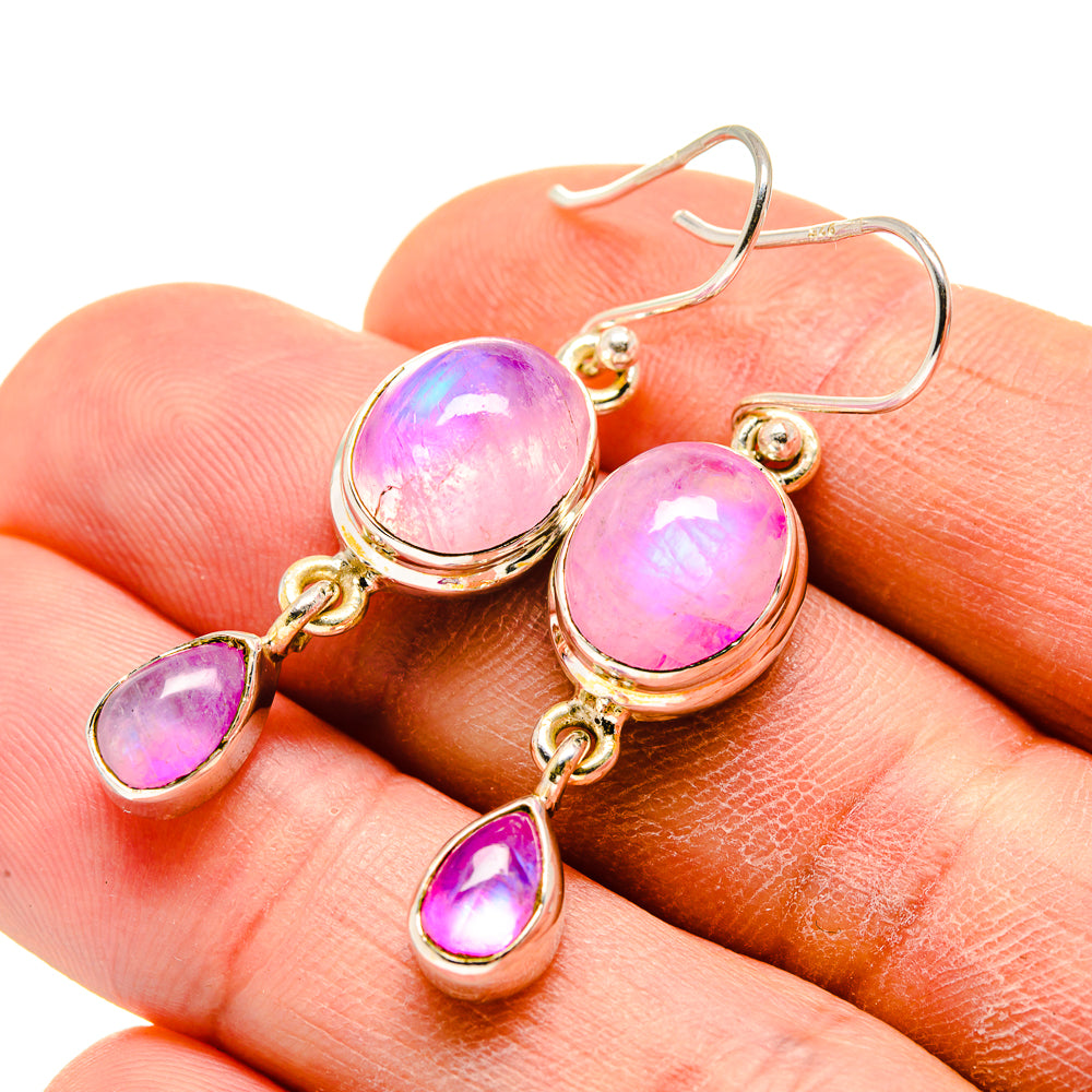Gold-tone drop earrings with round pink stones and small teardrop charms