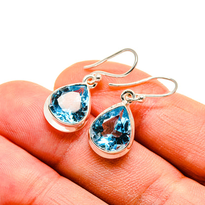 Blue topaz teardrop earrings in sterling silver, close-up on lever backs