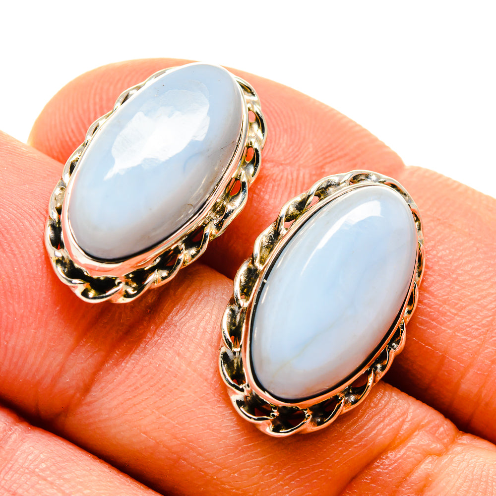 Oval opal stud earrings, light blue cabochon with gold-tone rope-like border