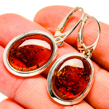 Amber drop earrings in silver-tone setting with round amber cabochons, hinged hoop backs