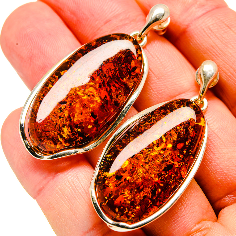 Amber oval drop earrings with dark speckled amber and silver-tone hinged hoops
