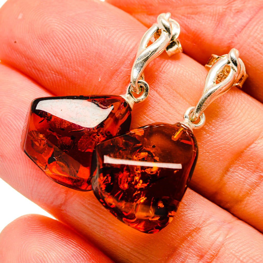 Amber drop earrings with red-brown Baltic amber stones and silver-toned hooks