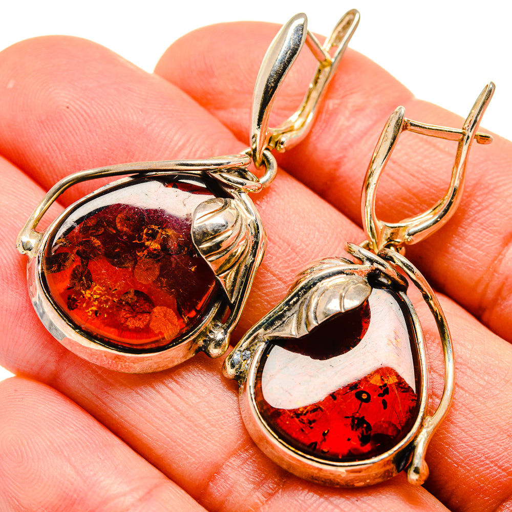 Baltic amber teardrop earrings on silver hooks, amber red stones in oval frames