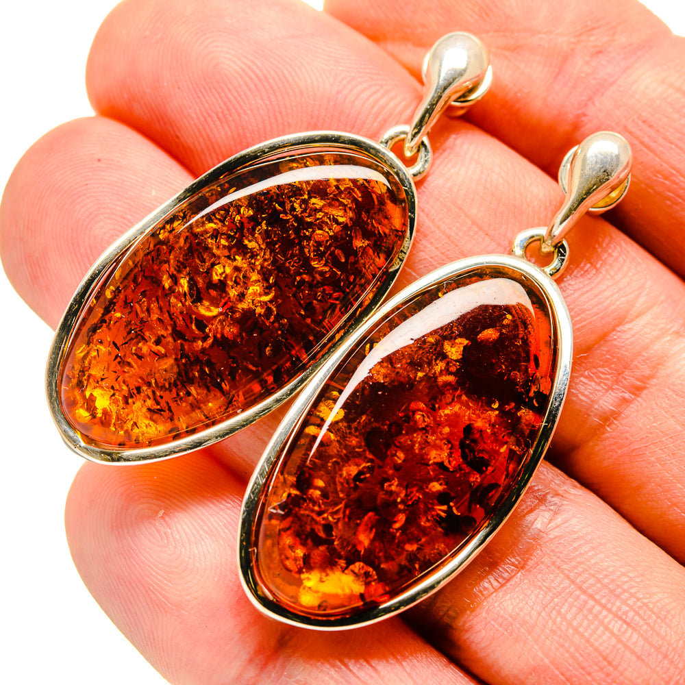 Amber teardrop earrings in 925 sterling silver with oval amber stone, gold-tone hooks
