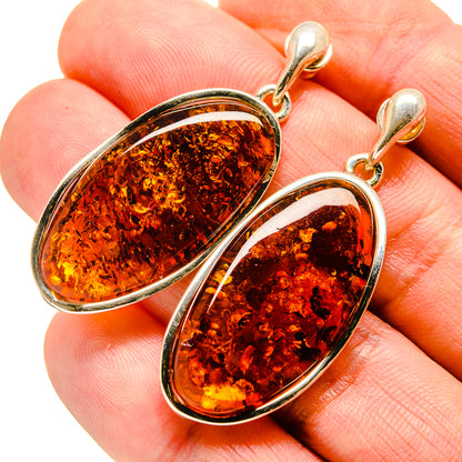 Amber teardrop earrings in 925 sterling silver with oval amber stone, gold-tone hooks