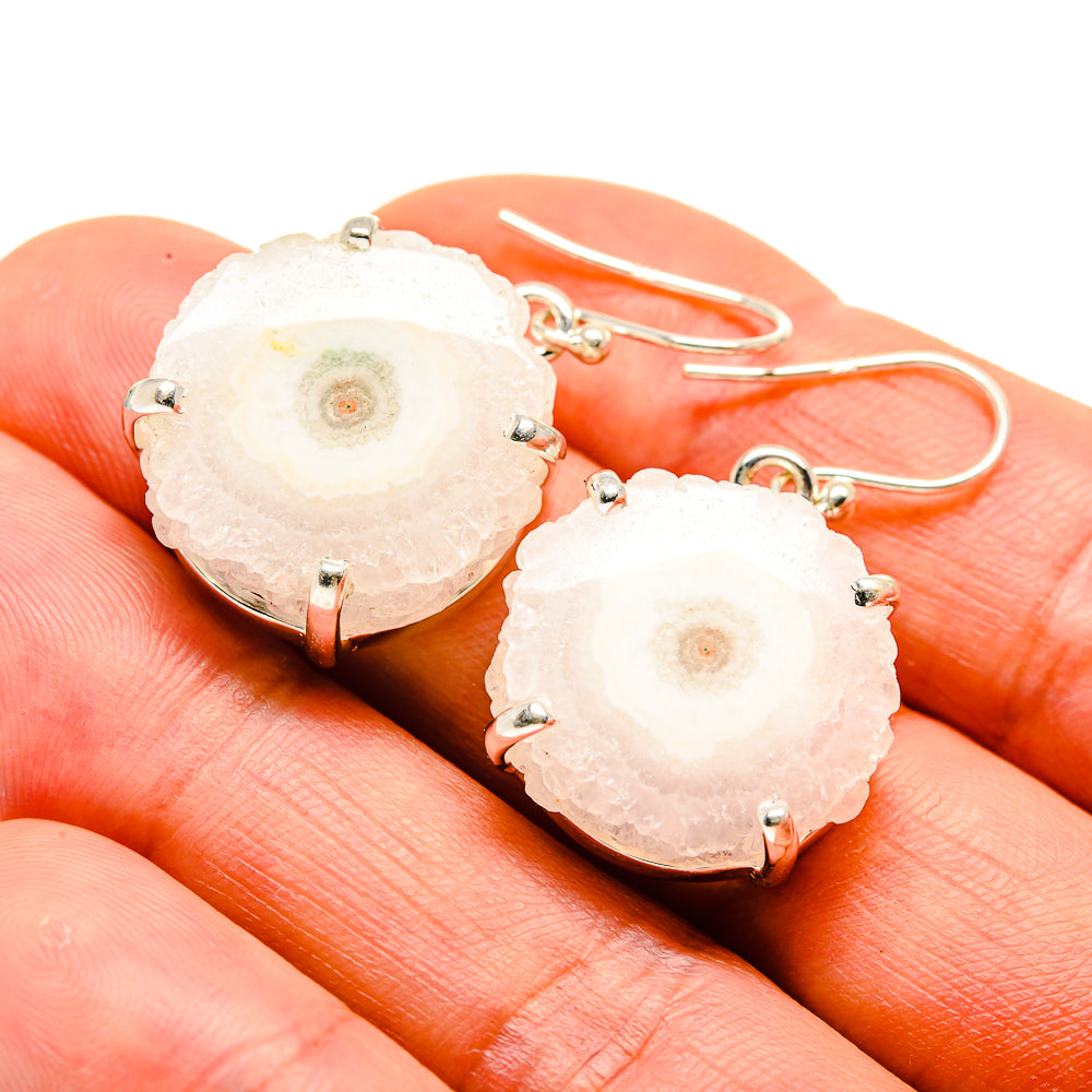 Solar quartz slice drop earrings in sterling silver with prong settings on hooks