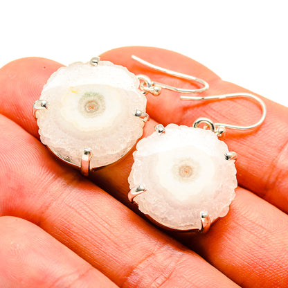Solar quartz slice drop earrings in sterling silver with prong settings on hooks