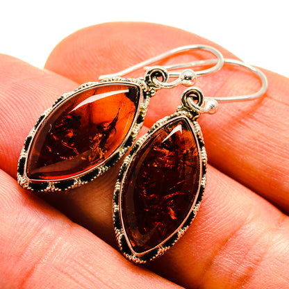 Teardrop amber earrings in ornate 925 sterling silver, amber-red stone on hooks.