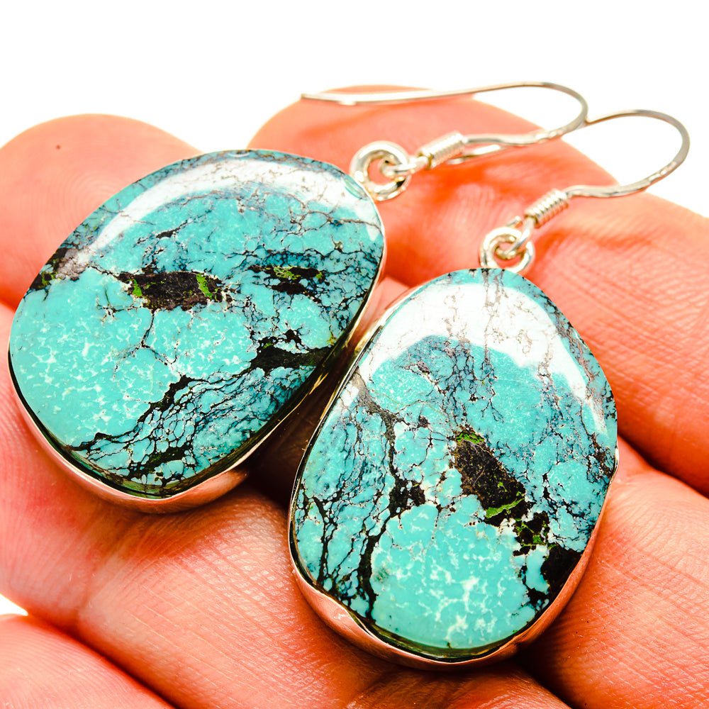 Turquoise oval stone earrings with silver-tone hook and bezel edge