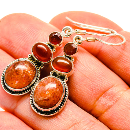 Carnelian drop earrings with red-orange stones in round silver-tone bezels