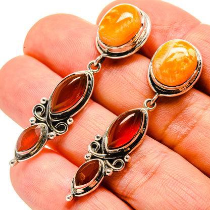 Carnelian and sunstone earrings with orange-red oval stones in ornate 925 silver settings