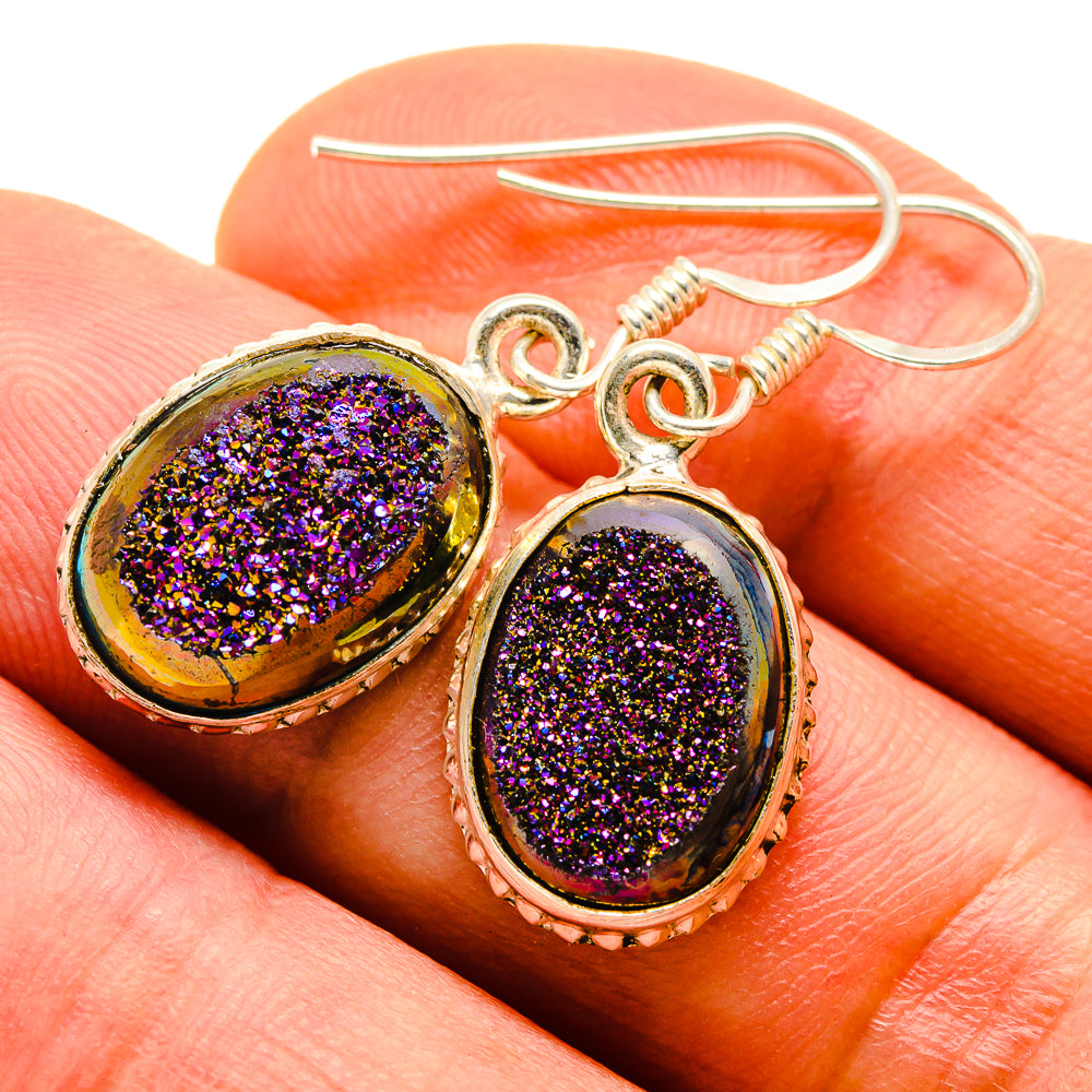 Close-up oval druzy earrings, dark purple glitter stones in gold-tone setting