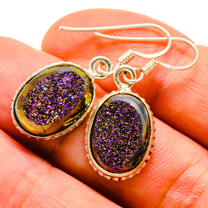 Close-up oval druzy earrings, dark purple glitter stones in gold-tone setting