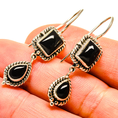 Gold-tone black onyx earrings with square top and teardrop dangle on posts
