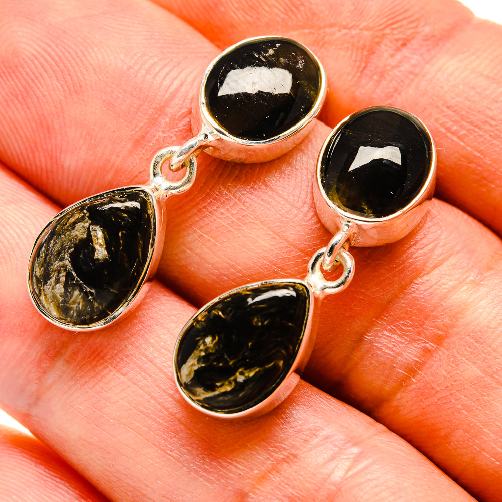 Oval gold-and-black seraphinite drop earrings with sterling silver hooks, close-up