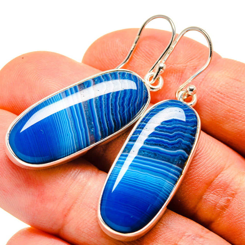 Blue striped agate oval drop earrings in sterling silver, close-up on hooks