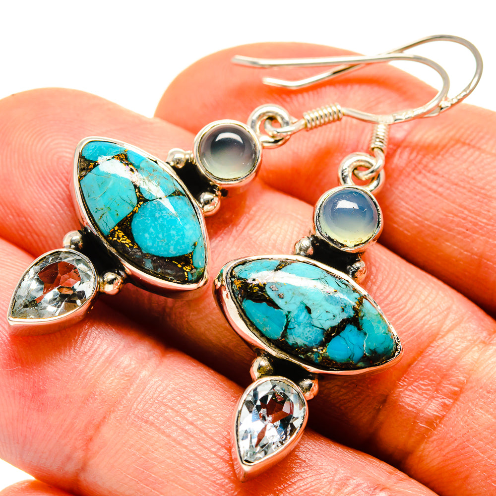 Closeup teal oval earrings with round blue stone, clear teardrop crystals, and hooks