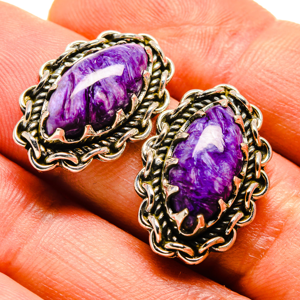 Oval purple gemstone earrings with ornate silver-tone filigree settings
