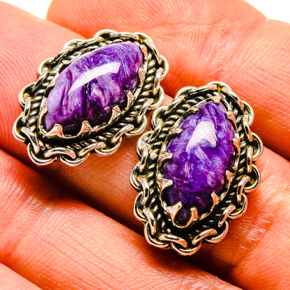 Oval purple gemstone earrings with ornate silver-tone filigree settings