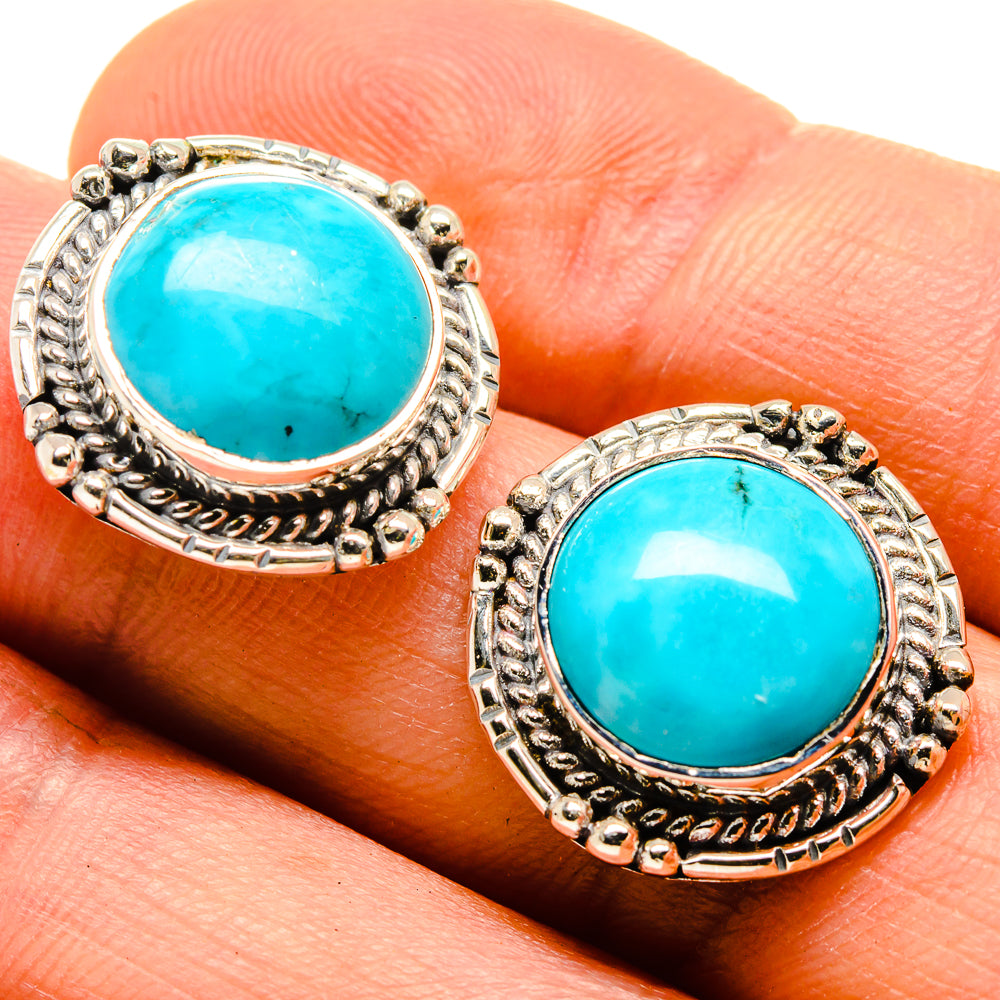 Turquoise cabochon stud earrings close-up in 925 sterling silver oval frames