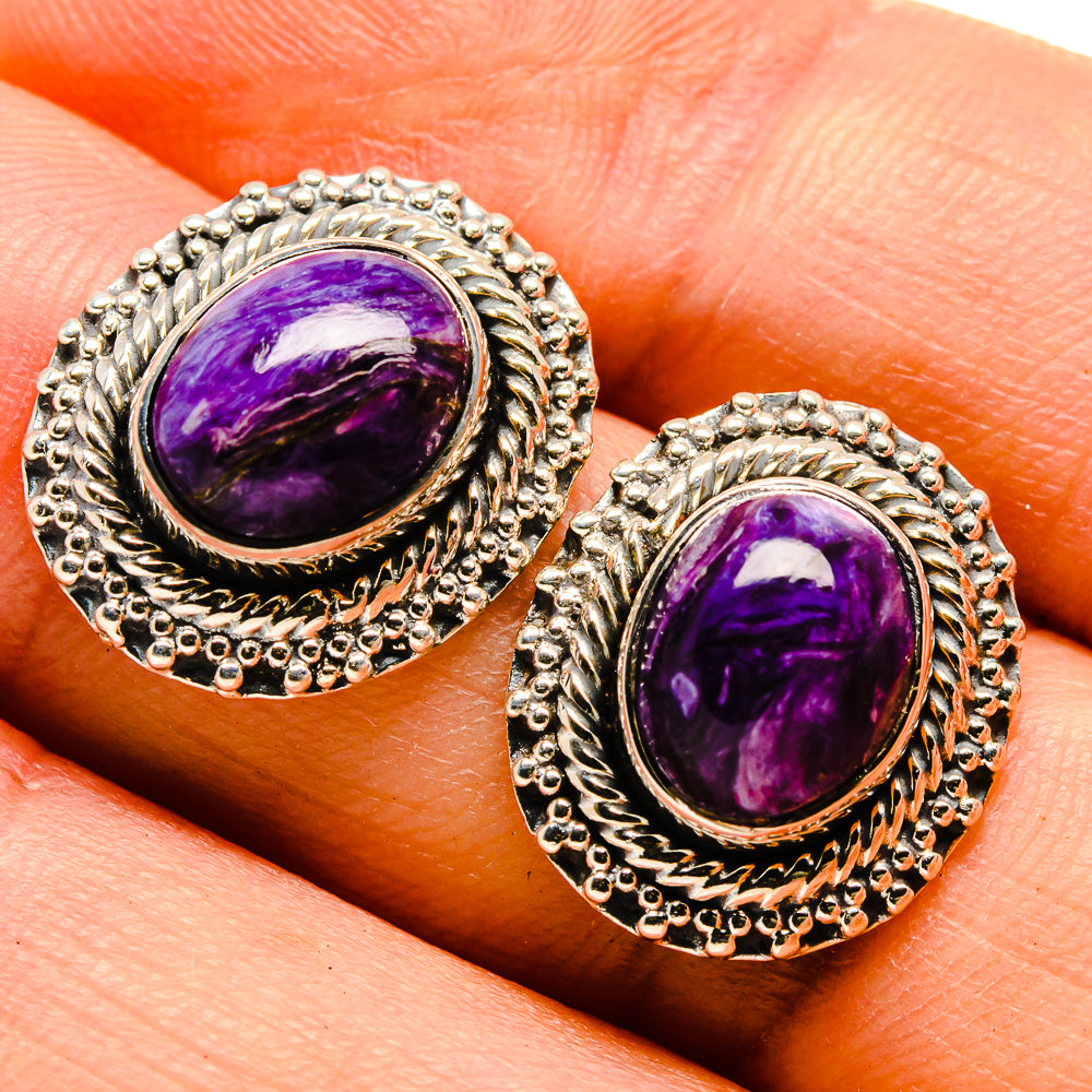 Sterling silver charoite earrings showing purple oval cabochon with engraved frame