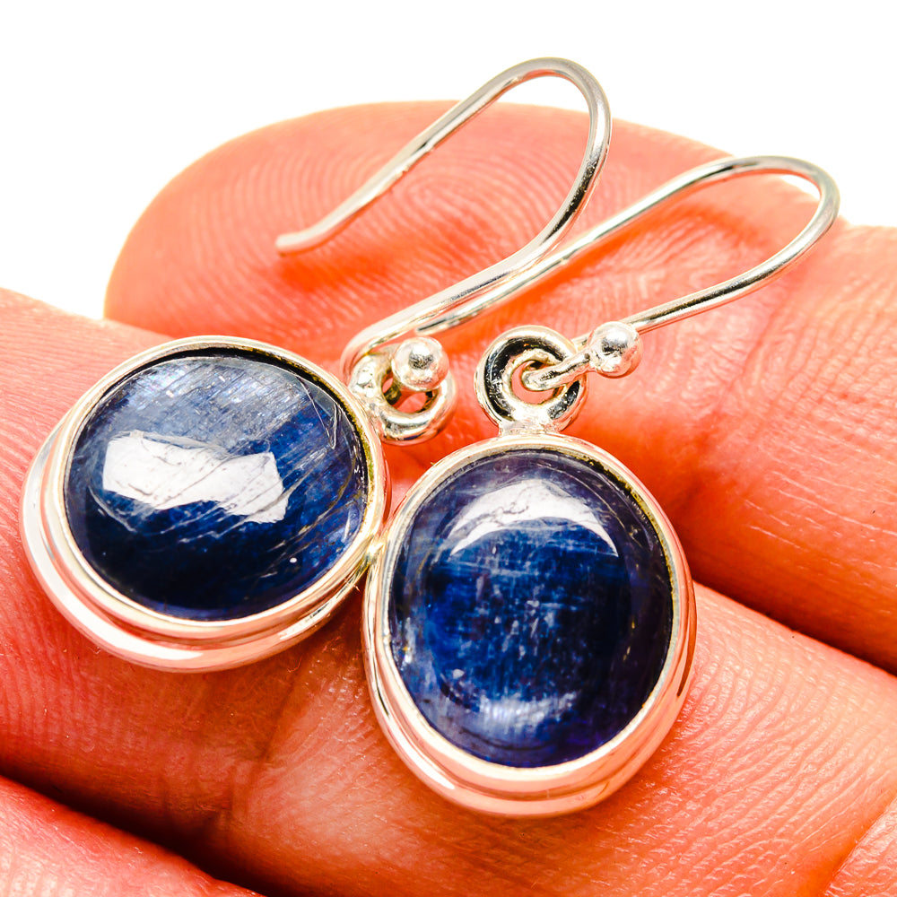 Blue oval cabochon kyanite earrings with sterling silver hook settings, close-up