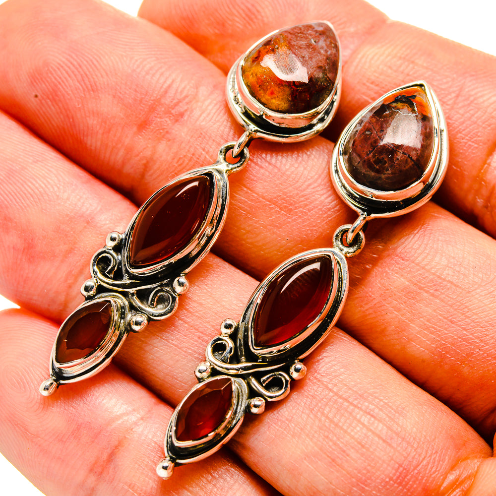 Red onyx and jasper teardrop earrings, close-up view of dangling stones in silver setting