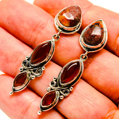 Red onyx and jasper teardrop earrings, close-up view of dangling stones in silver setting