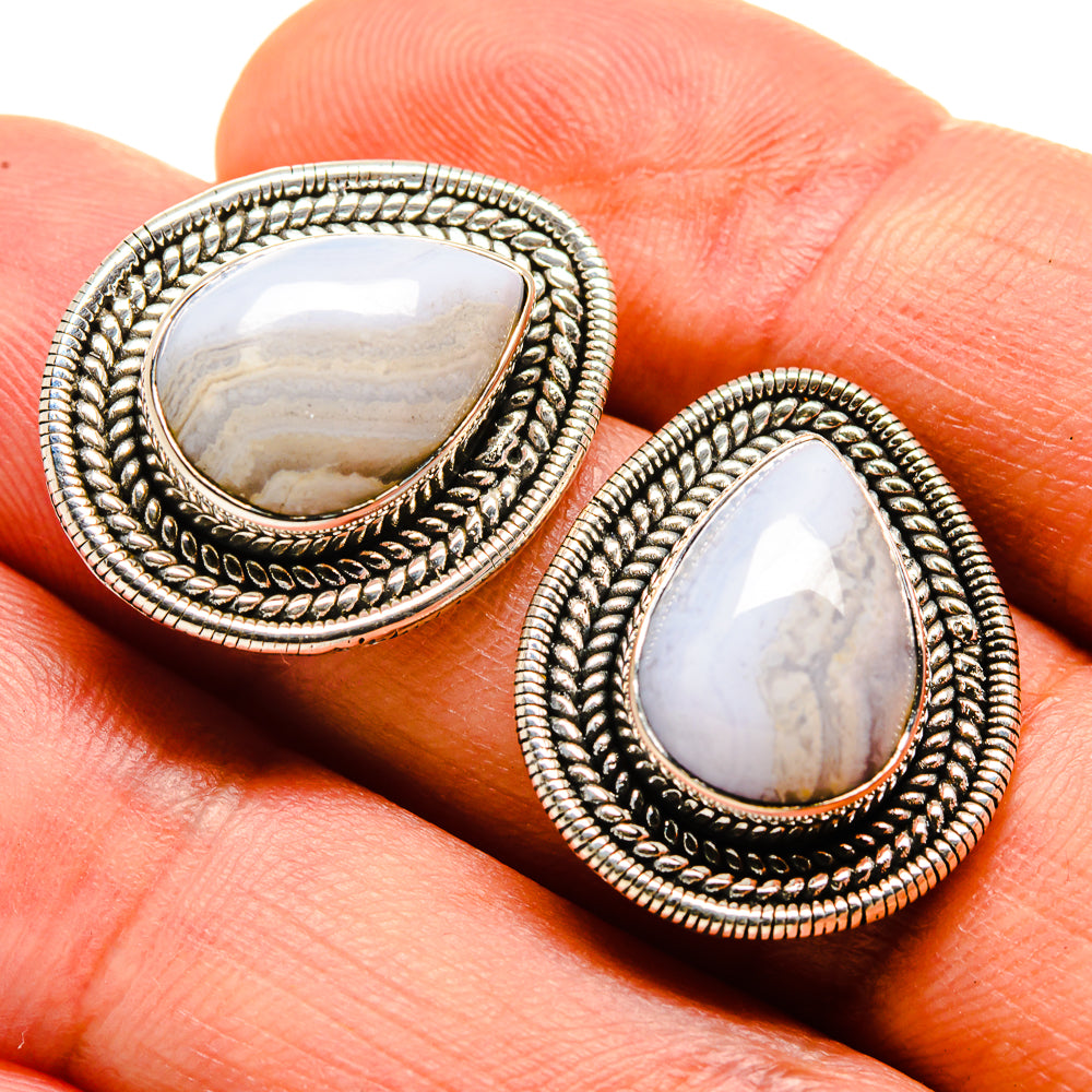 Teardrop gemstone stud earrings in silver-tone with patterned halo and cabochon centers