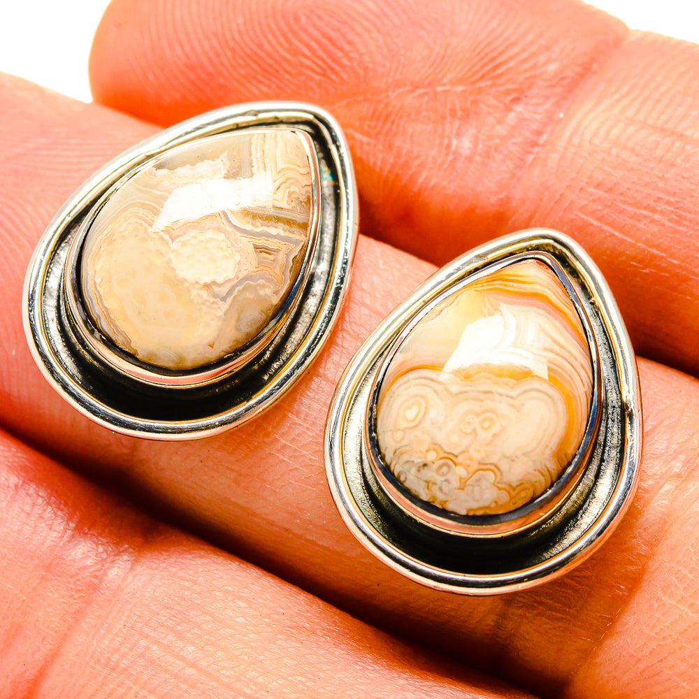 Teardrop agate earrings with silver bezel, cream and orange banded stone.