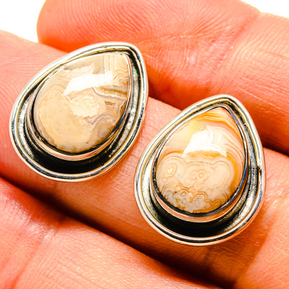 Teardrop agate earrings with silver bezel, cream and orange banded stone.