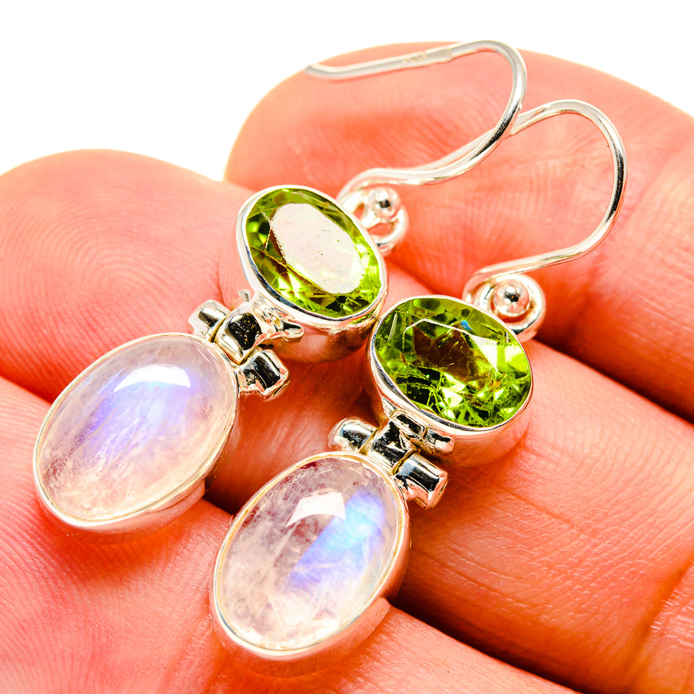 Sterling silver earrings close-up: green peridot ovals with iridescent moonstone teardrops